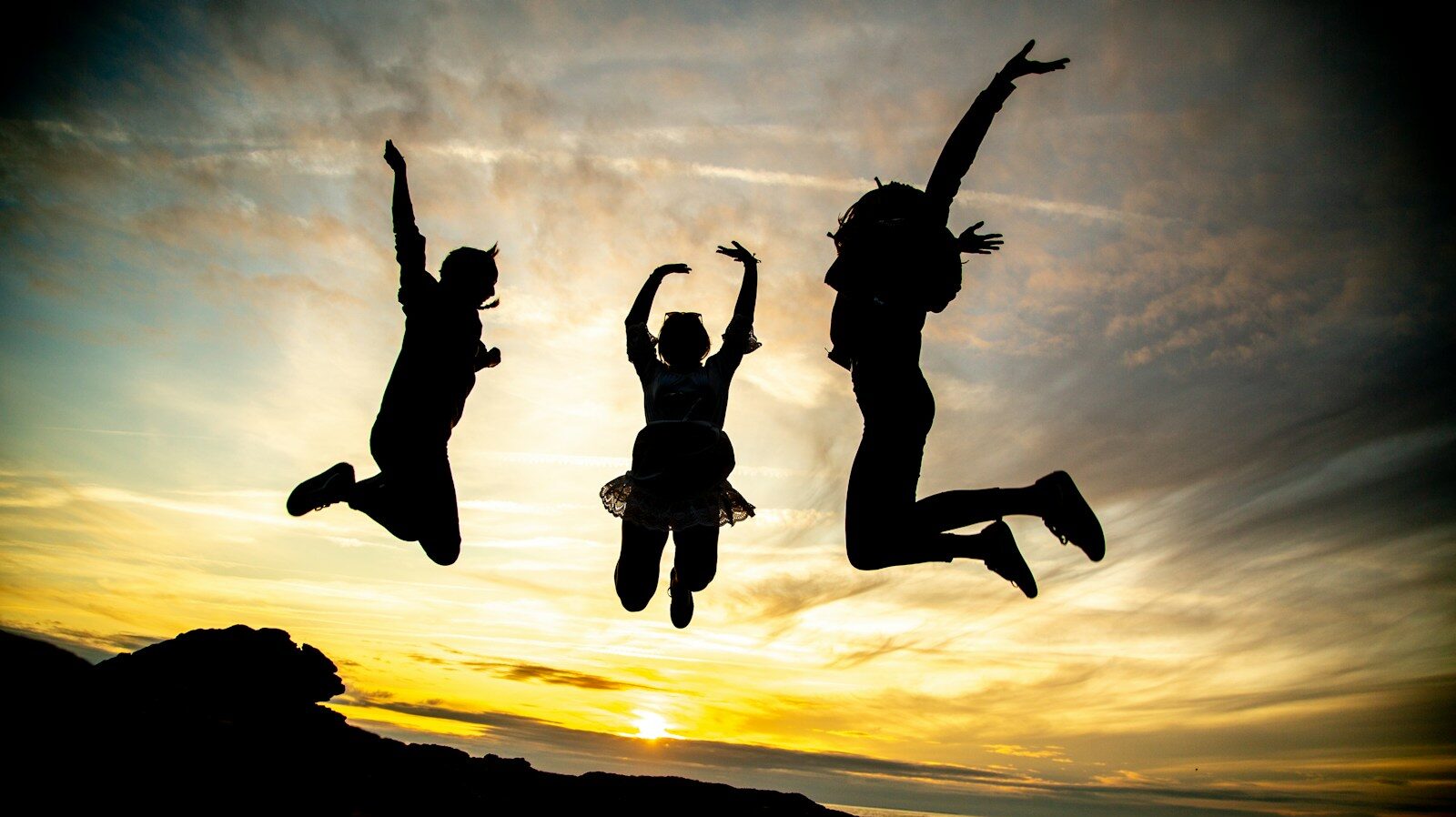 silhouette of jumping people